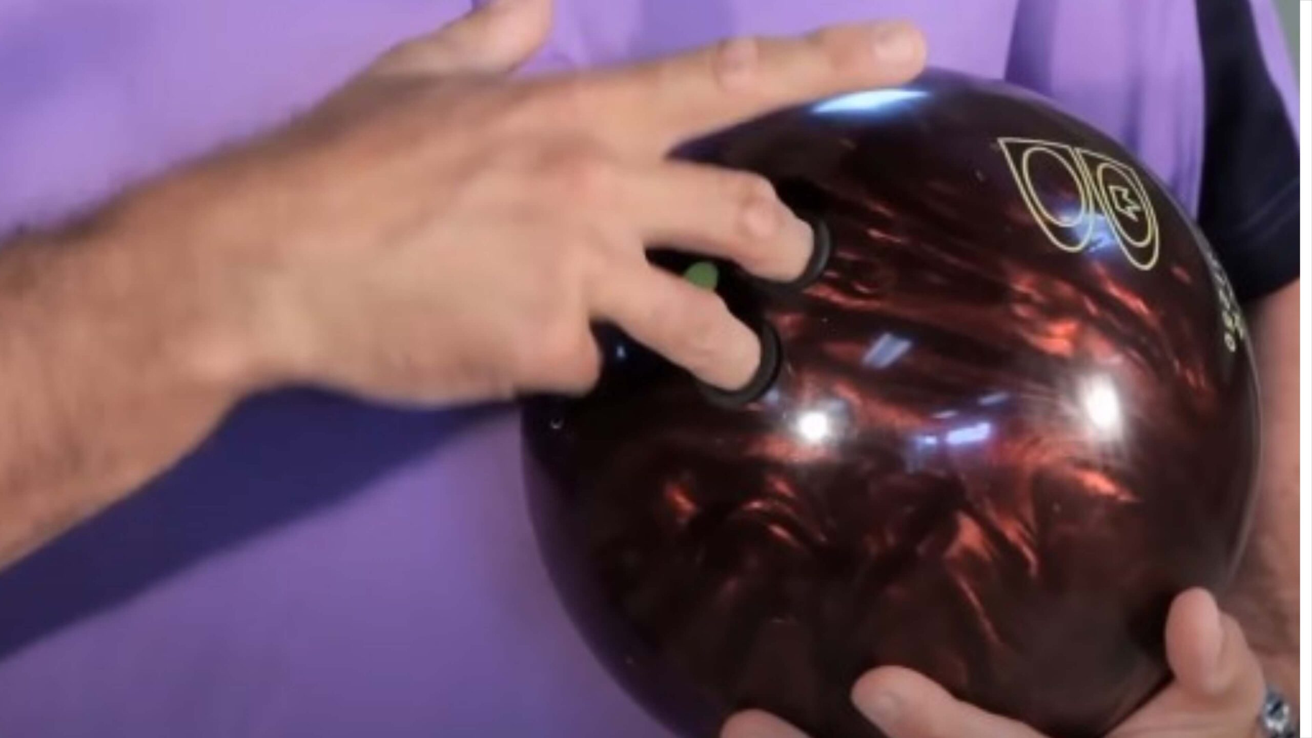 bowler holds a bowling ball with mass